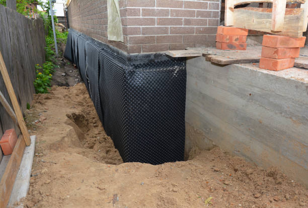 SJ Waterproofing Pros technician performing targeted Vapor Barrier Installation assessment in Bessemer, MI